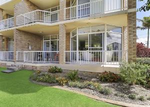 a large house with balconies and a yard at Solitaire 1 in Sawtell