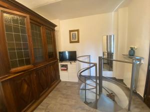 a spiral staircase in a room with a refrigerator at Alloggio Sassi in Turin