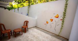 a room with two chairs and a wall with flowers at Göcek Lykia Resort Premium Concept Hotel in Göcek