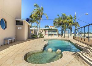 a swimming pool in the middle of a building at Ocean Pines in Nambucca Heads