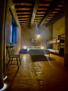 a bedroom with a bed and a table and a chair at Agriturismo Il Covo del Solengo in Valtopina