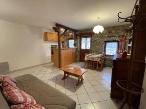 a living room with a couch and a table at Maison Vallouise, 2 pièces, 4 personnes - FR-1-330G-140 in Puy-Saint-Vincent