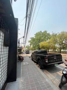un camión estacionado en una calle al lado de un edificio en W2 Hostel en Chiang Mai