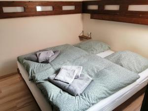 a bedroom with a bed with two towels on it at Ferienhaus 30 am Silbersee in Frielendorf