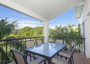 a patio with a table and chairs on a balcony at 1/17 22nd Ave - Sawtell, NSW in Sawtell