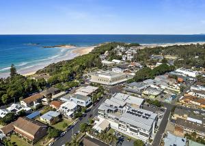an aerial view of a city and the beach at Periwinkle in Sawtell