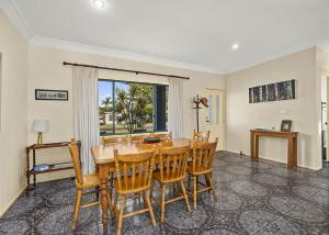 a dining room with a table and chairs at Ronnie s Cottage in Mylestom