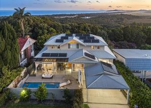 an aerial view of a house with solar panels on it at Sea Breeze in Coffs Harbour