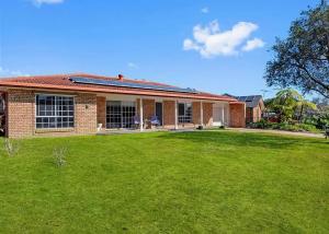 a brick house with a lawn in front of it at Geoff and Mary s in Urunga