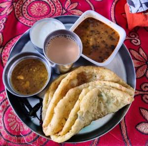 a plate of food with a plate of food with soup at ASTHA GUEST HOUSE in Gopeshwar +11 photos