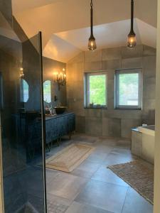 a large bathroom with a shower and a sink at Modern stor villa nära havet och 10 min till city in Gothenburg