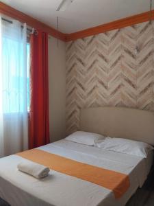 a bedroom with a large bed with a red curtain at Mtwapa luxury Gold Star 3br in Kilifi