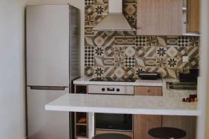 a kitchen with a white counter and a refrigerator at Blue in Green South in Kastrosikia