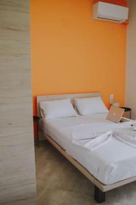 a bedroom with a bed with a laptop on it at Blue in Green South in Kastrosikia