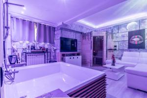 a large white bath tub in a living room at THESPASUITE Suite e Spa privata per coppie in Rome