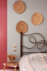 a bedroom with a bed with baskets on the wall at Boho House Florina in Florina