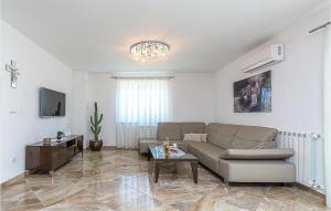 a living room with a couch and a table at Stunning Apartment In Buje With House A Panoramic View in Buje