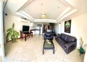 a living room with a couch and a table at Andaman Hill Pool Seaview in Patong Beach