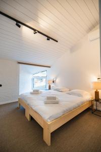 a large bedroom with a large bed in a room at Village du Caillou in Dinant