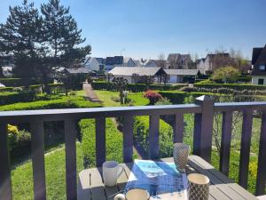 stół na balkonie z widokiem na dziedziniec w obiekcie Charmant Duplex Près de la Plage à Cabourg - Balcon Sud, 4 pers., Tout équipé - FR-1-465-93 w mieście Cabourg