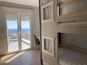 a room with a bunk bed with a view of the ocean at Zax sea view villas in Ierápetra