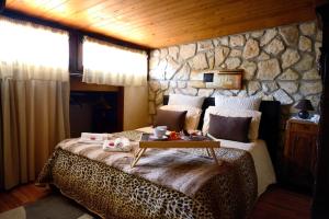 a bedroom with a leopard bed with a table on it at Alla Corte dei Ventimiglia in Montelepre