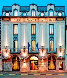 a building with a hotel royal exchange on the front at Hotel Royal Falcone in Monza