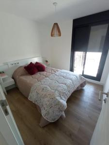 a bedroom with a bed in a white room at Apartamento nuevo, centrico y con vista a la bahia in Montevideo