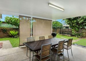 a dining room table and chairs in a backyard at Nonna and Pops in Mylestom