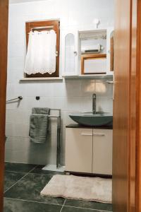 a bathroom with a sink and a mirror at Apartments Potočki in Medulin