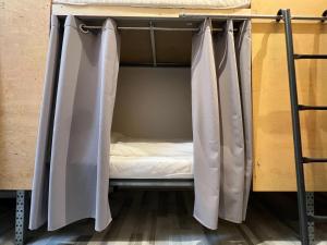 a bunk bed with curtains in a room at The Old Factory in Copenhagen