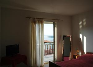 a bedroom with a window with a view of the ocean at Babo Apartments in Hvar