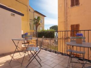two tables and chairs on a balcony with a fence at City Center “Casa Giuliana” in Perugia