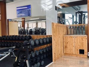 a gym with rows of dumbbells and weights at Wellness Hotel Aquafit Sursee in Sursee