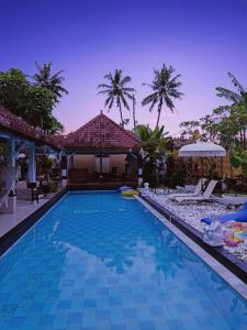 a swimming pool in front of a villa at Villa Padi Pakem in Pakem