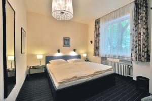 En eller flere senge i et værelse på Hotel Am Ehrenhof