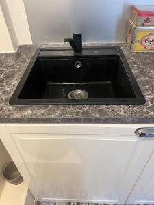 a black sink in a kitchen with a counter at Charm'in Champigny: Studio cosy, détente & travail in Champigny-sur-Marne