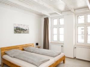 Ein Bett oder Betten in einem Zimmer der Unterkunft Ferienwohnungen Merl