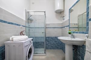 a bathroom with a washing machine and a sink at Casa Vacanze San Michele in Alghero +141 photos