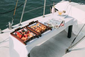 a table with a tray of food on a boat at Scarlet Pearl Cruises in Ha Long