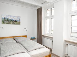 Ein Bett oder Betten in einem Zimmer der Unterkunft Ferienwohnungen Merl