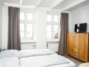 Ein Bett oder Betten in einem Zimmer der Unterkunft Ferienwohnungen Merl