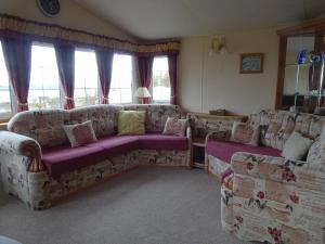 a living room with a couch and two couches at Asgard in Big Sand