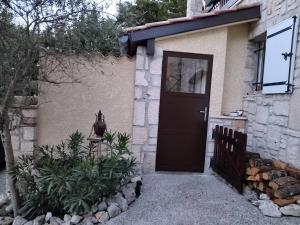 a black door of a house with plants in front at Les Lauriers Roses in Salavas +32 photos