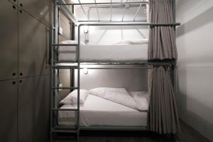 a bunk bed room with two bunk beds at Man Cave Hostel Vientiane in Ban Nongdouang