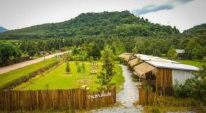 an aerial view of a farm with a fence at เติมเต็มคาเฟ่&แคมป์ปิ้ง by สวนเขาจุก in Ban Noen Sombun