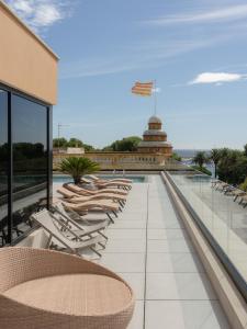 a row of lounge chairs on the roof of a building at Elke Spa Hotel in Sant Feliu de Guixols
