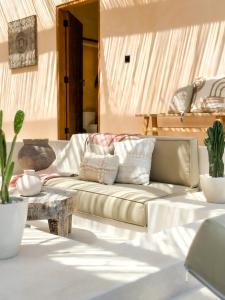 a living room with a couch and a table at Villa Mahuwa in Canggu