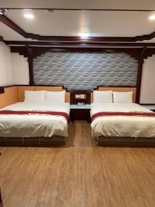 Postel nebo postele na pokoji v ubytování Mei Hua Hotel