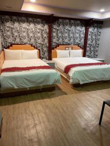 Postel nebo postele na pokoji v ubytování Mei Hua Hotel